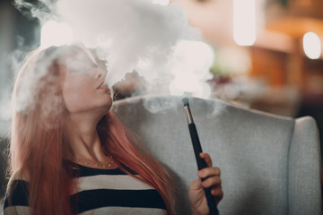 Young beautiful female smoking hookah. Smoke shisha hookah concept.