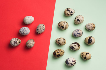 heap of quail eggs on green and red background. Vegetarian organic  eco food.  Top view. flatlay