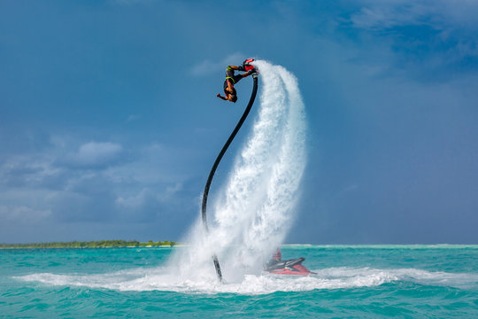 Professional pro fly board rider in tropical sea, water sports concept background. Summer vacation fun outdoor sport