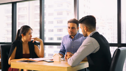 Successful team at work. Group of young business people working and communicating together in creative office