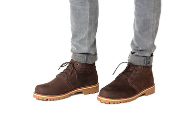 Fashion men’s legs in jeans and brown boots leather for man collection isolated on a white background. Clipping path