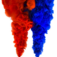 The swirl of ink in water isolated on white background. Red and blue paints mix in water close-up