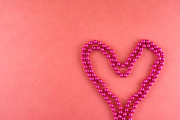 Pink beads on pink background.