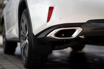 Obraz na płótnie Canvas Close up photo of modern luxury sport car suv elegant design mufflers tailpipe.