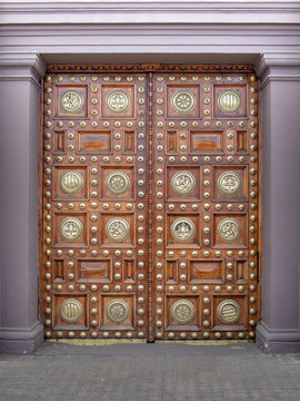 Beautiful antique wooden door with the bronze decorative ornament