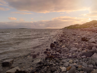 Fototapeta na wymiar Sunset on west coast of Ireland, Galway bay, Atlantic ocean, Hare island in the background.