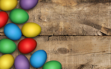 Colored easter eggs on wooden background. Rustic background, decoration. Colorful Easter eggs on a wooden table. Invitation template design, greeting card, place for text