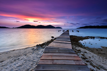 Fototapeta na wymiar Sunset over the wooden jetty in marina island, perak