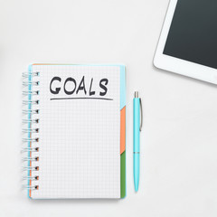 Business goals. Career priorities. Time management. Result to achieve. Notepad mockup. Pen and tablet at hand.