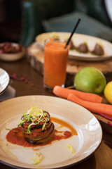 Baked vegetables in layers, fruits and carrot juice