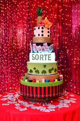 casino cake on red background, 6 tier , themed cake, multicolored cake on red background, casino party, casino theme cake on red background, red light curtain, glitter curtain, cake table, holiday