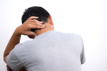 Rear view of a young man holding his neck in pain