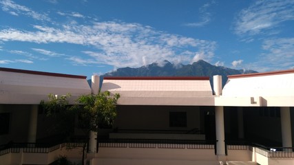 clouds and mountains over building