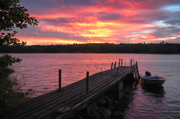 Fototapeta premium Evening ambiance at Golf of Finland. Boat and seagul on jetty.