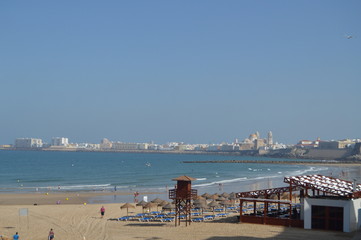 Obraz premium Views Of The Historic Center Of Cadiz From The Beach Of Santa Maria Del Mar. Nature, Architecture, History, Street Photography. July 10, 2014. Cadiz, Spain.
