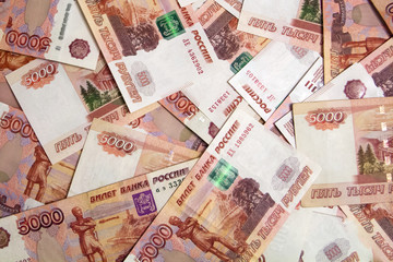 Banknotes of Russian currency face value of 5,000 rubles scattered on the table are a sign of riches and prosperity.