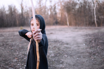 girl with bow in the forest