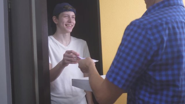 pizza delivery concept. teen boy delivers a box of pizza lifestyle. slow motion video. fast food concept fast food delivery
