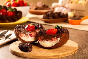 Gourmet easter egg, stuffed with chocolate and strawberry. Easter egg with pudding cream, Easter dessert. Easter concept.