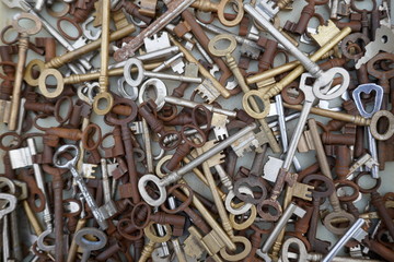 Many different old, rusty keys to sell at the flea market. Close up, background and texture