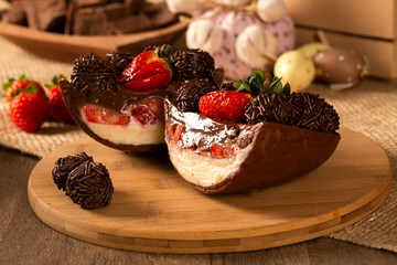 Gourmet easter egg, stuffed with chocolate and strawberry. Easter egg with pudding cream, Easter dessert. Easter concept.