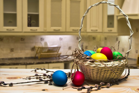 Wicker Basket Full Of Easter Eggs On The Kitchen Table