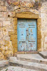 Fototapeta na wymiar Beautiful old, light blue painted, weathered, locked door at Rabat Malta
