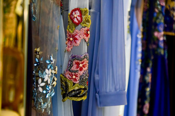 blue dresses with embroidered flowers, clothing store, tone sur tone, colorful dresses with intricate beadwork and embroidery, beautiful high fashion clothes for an event, elegant designer dresses 