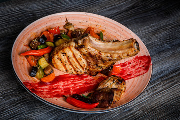 top view closeup big piece of grilled rib with meat steak with grilled vegetable