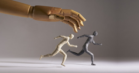 Men run under the threat of a giant hand. Isolated On gray background. With copy space text. Studio Shot.