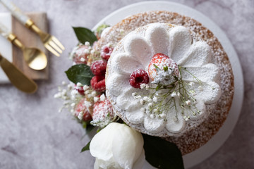 White cake Decorated with flower and berries. For celebrate party weddings, birthdays and events.