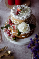 White cake Decorated with flower and berries. For celebrate party weddings, birthdays and events.
