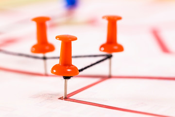Street map with thumbtacks forming a route