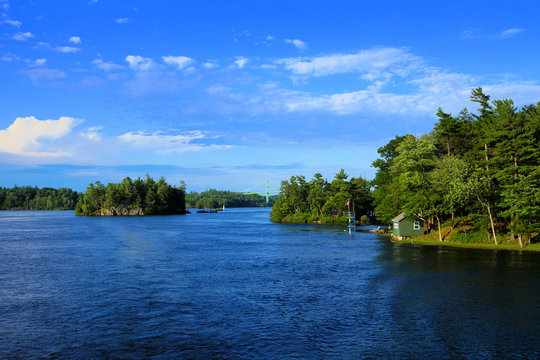 Peaceful landscape of the Thousand Islands during summer with bridge in background along Canada USA border