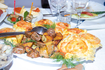 Hot on the holiday table. Meat in French. Baked meat with mushrooms. Dishes on the holiday table.