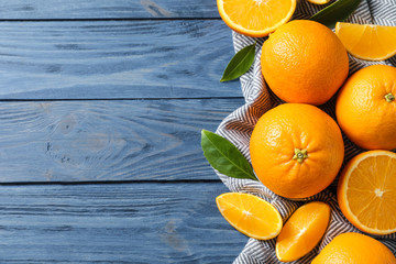 Flat lay composition with ripe oranges and space for text on wooden background