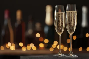 Fotobehang Glasses of champagne on table against blurred background. Space for text © New Africa