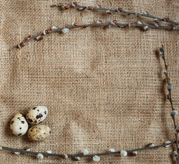 Easter day. A small nest with quail eggs on a sackcloth background, texture of burlap. With free space for text input, logo, etc.