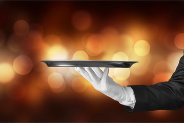 Elegant waiter hand in white glove holding an empty plate