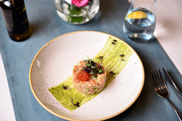 salmon tartare with red caviar on a plate
