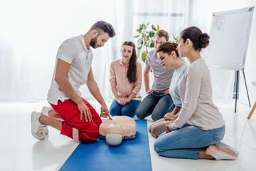 instructor gesturing during first aid training with group of people