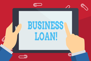 Writing note showing Business Loan. Business concept for creation of debt which will be repaid with added interest Businessman Hand Holding and Pointing Colorful Tablet Screen