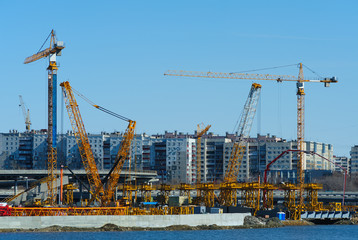 Fototapeta na wymiar Construction cranes at work