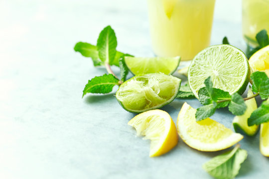 Ingredients for making a summer lemonade; lime and lemon, fresh mint leaves. Close-up