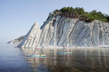 Young couple paddling on SUP board
