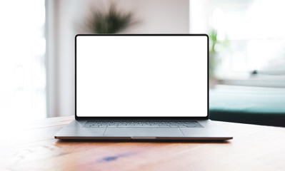 Laptop blank screen mockup on table in living room - front view