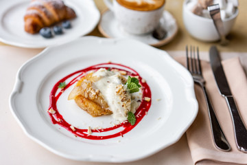 French toast style brioche with vanilla ice cream, pear, nut, mint leaf and red berry sauce. Light morning Breakfast, fresh warm pastries and aromatic cappuccino coffee
