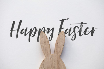 Wooden easter bunny ear message on a plain white background