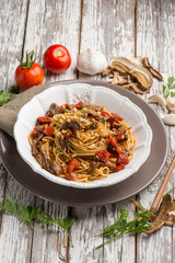 spaghetti with dried mushroom crumbs and tomatoes
