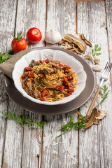 spaghetti with dried mushroom crumbs and tomatoes
